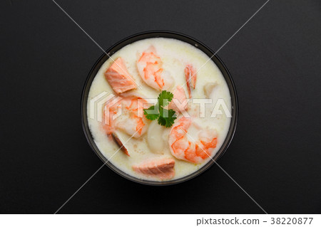 Tom kha soup with seafoods over dark background. 38220877