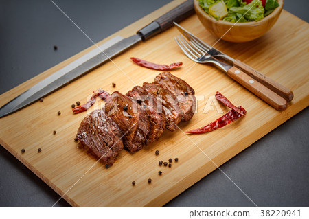 Duck meat on a wooden board. Duck meat on a wooden board. 38220941