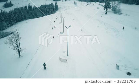 Aerial view of a snow covered alpine skiing slope 38221709