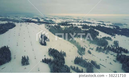 Aerial view of a snow covered alpine skiing slopes 38221710