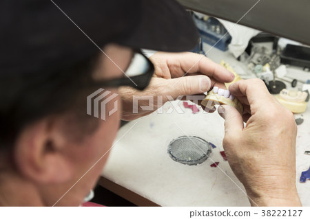 Dental Technician Works On 3D Mold Tooth Implants 38222127