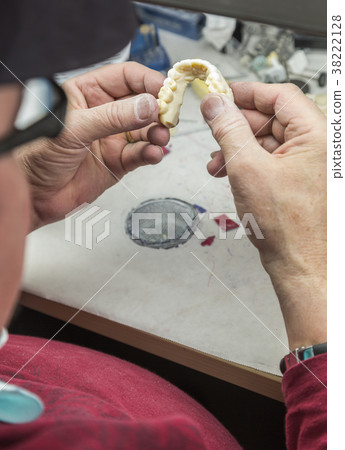Dental Technician Works On 3D Mold Tooth Implants 38222128