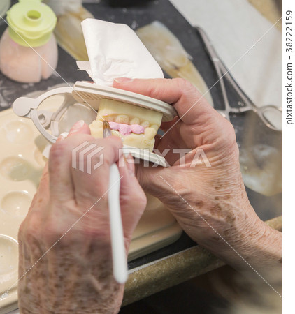 Dental Technician Works On 3D Mold Tooth Implants 38222159