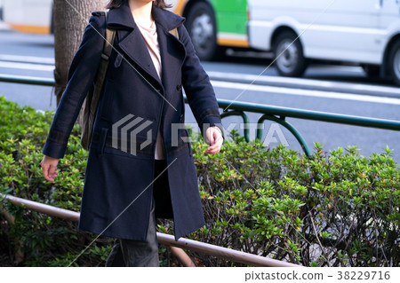 Woman walking in town 38229716