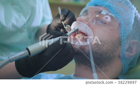 Doctor examining a patient with a retractor in the Doctor examining a patient with a retractor in the 38229897