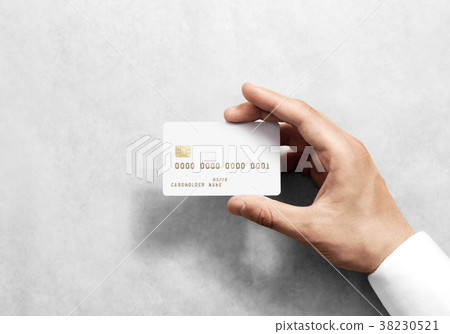 Hand holding blank white credit card mockup with  38230521