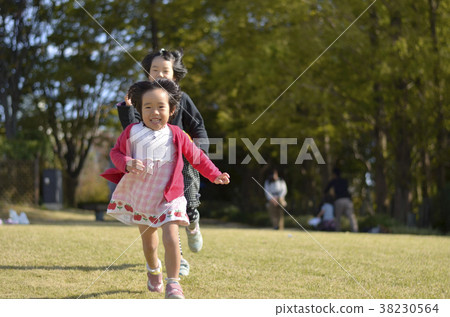 Sisters running in the park 38230564