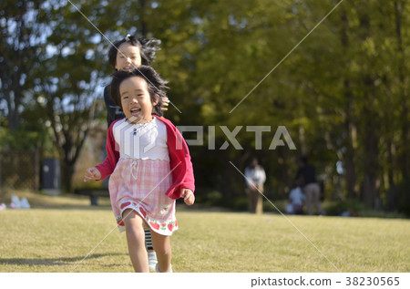 Sisters running in the park 38230565