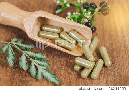 Herbal medicine capsules from herb on rustic wood Herbal medicine capsules from herb on rustic wood 38231663
