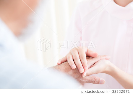 Young nurse and grandpa hold hands Hand touch Retirement home Day care center Wheelchair 38232971