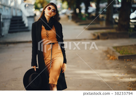 stylish girl walking through the city stylish girl walking through the city 38233794