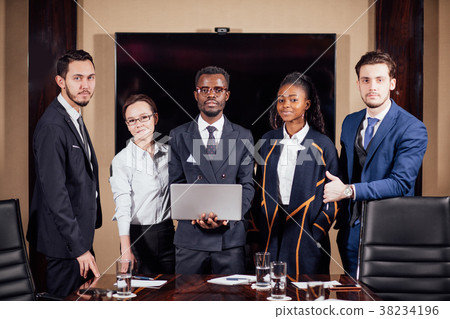 business team standing in meeting rom and looking business team standing in meeting rom and looking 38234196