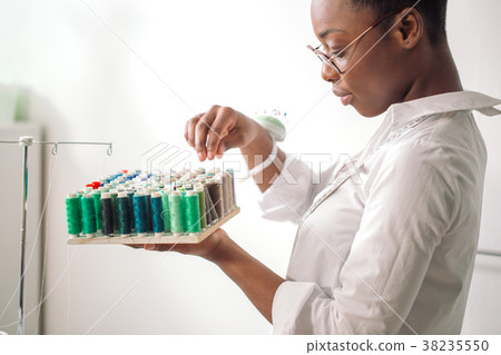 african seamstress holding coils with threads african seamstress holding coils with threads 38235550