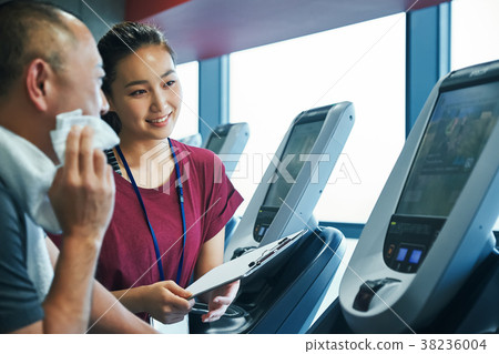 Gym running machine trainer and senior man 38236004