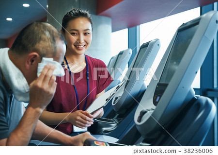 Gym running machine trainer and senior man 38236006