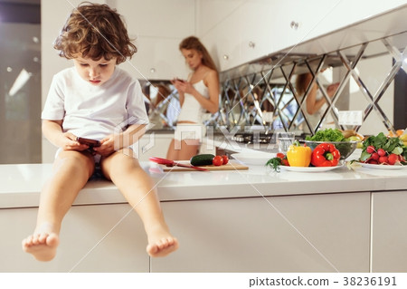 Mom with her child cooking in the kitchen. casual Mom with her child cooking in the kitchen. casual 38236191