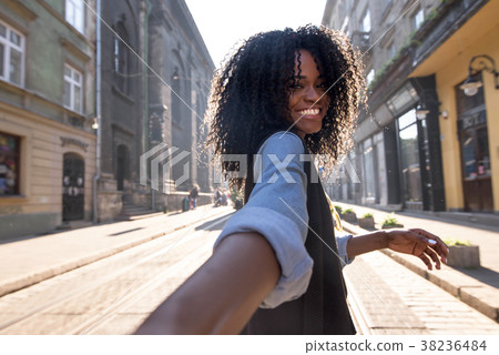 Outdoor portrait of attractive dark-skinned woman 38236484