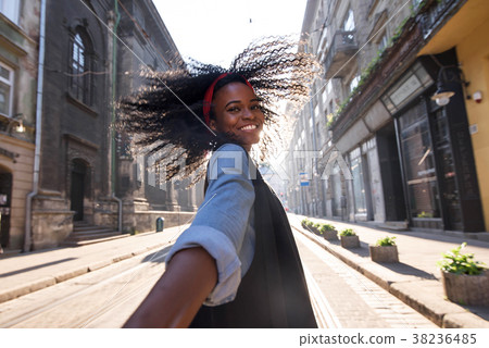 Photo of happy black girl walking on the street Photo of happy black girl walking on the street 38236485