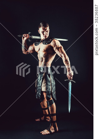 Severe barbarian in leather costume with sword 38236887