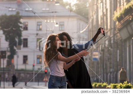 One black girl with her friend making selfie in a One black girl with her friend making selfie in a 38236984