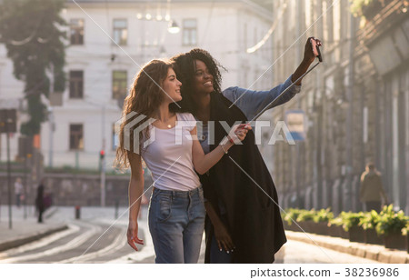 two young friends walking on the streets and 38236986