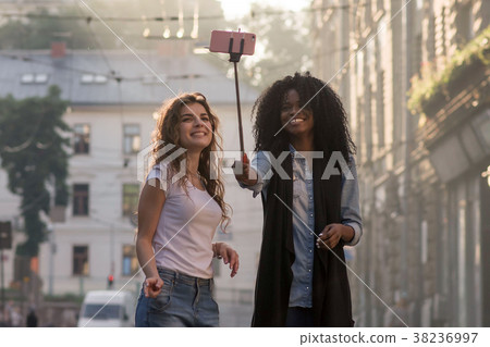 Happy girls making srlfie on a beautiful street 38236997