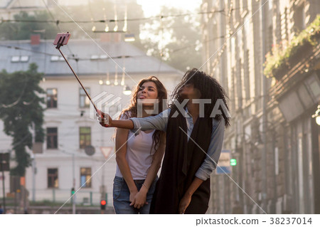 Two friends posing for camera making selfie. Happy Two friends posing for camera making selfie. Happy 38237014