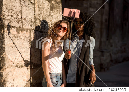 Two attractive girls wearing casual closes and 38237035