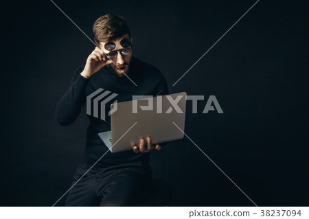 Shocked man in glasses looking at laptop 38237094