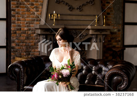 Bride in white dress sitting on chair  38237168