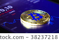 Golden bitcoins on the background of a graphic 38237218