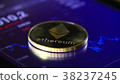 Gold coins of the ethereum on the background of a 38237245