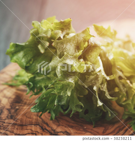 fresh green frillis salad on cutting board fresh green frillis salad on cutting board 38238211