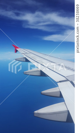 wing of aeroplane over blue sky background wing of aeroplane over blue sky background 38238669