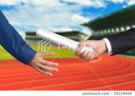 Businessman passing relay baton to colleague 38239484