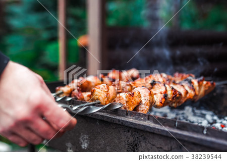 Grilled kebab cooking on metal skewer. Roasted Grilled kebab cooking on metal skewer. Roasted 38239544
