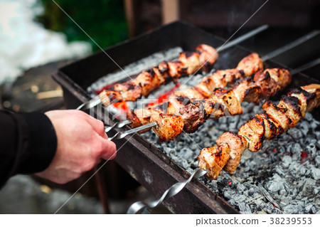 Grilled kebab cooking on metal skewer. Roasted Grilled kebab cooking on metal skewer. Roasted 38239553