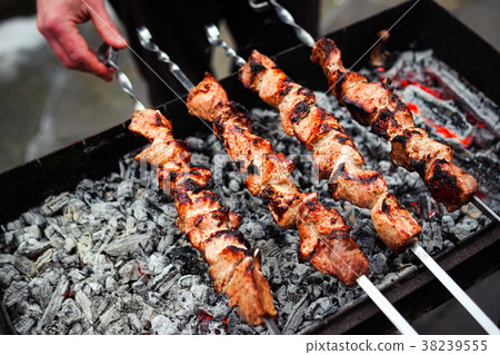 Grilled kebab cooking on metal skewer. Roasted 38239555