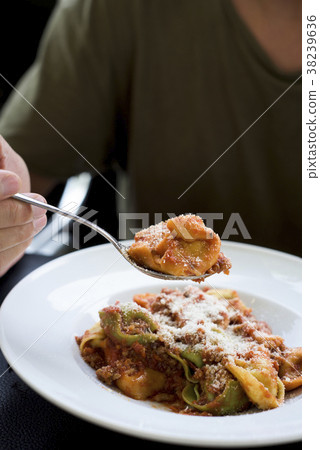 young man eating tortellini 38239636
