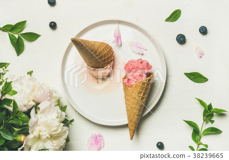 Flat-lay of ice cream scoops and peonies on plate 38239665