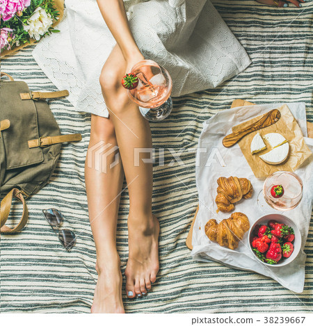 Woman in dress sitting with wine and snacks 38239667