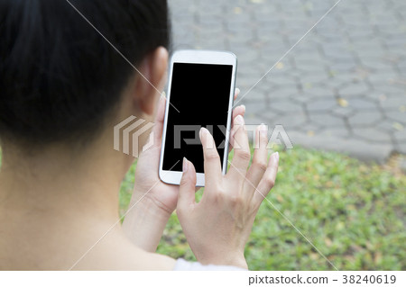 Woman hand holding mobile phone and touch screen Woman hand holding mobile phone and touch screen 38240619