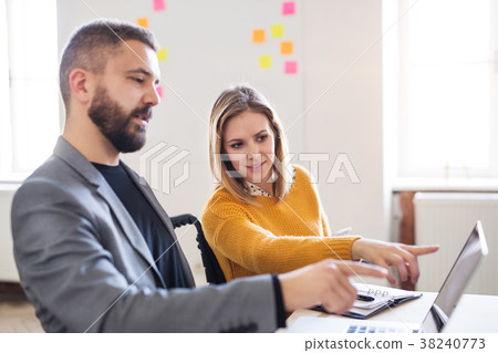 Two business people with wheelchair in the office. Two business people with wheelchair in the office. 38240773