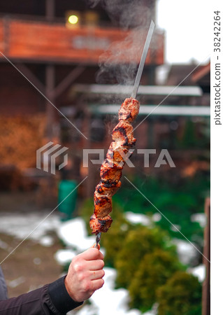 Grilled kebab cooking on metal skewer. Roasted 38242264
