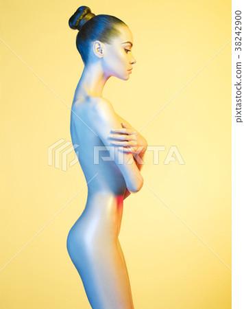 Elegant nude model in the light colored spotlights Elegant nude model in the light colored spotlights 38242900