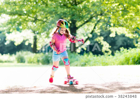 Child riding skateboard in summer park Child riding skateboard in summer park 38243848