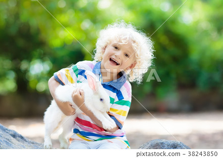 Child with rabbit. Easter bunny. Kids and pets. Child with rabbit. Easter bunny. Kids and pets. 38243850