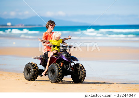 Kids on quad bike. Off road all terrain vehicle. 38244047
