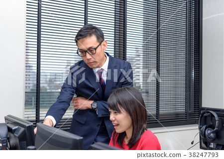Professor teaching university students studying in computer class Professor teaching university students studying in computer class 38247793