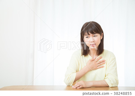 My heart is suffering palpitation shortness of breath Negative image physical condition poor female portrait 20's 30's 38248855